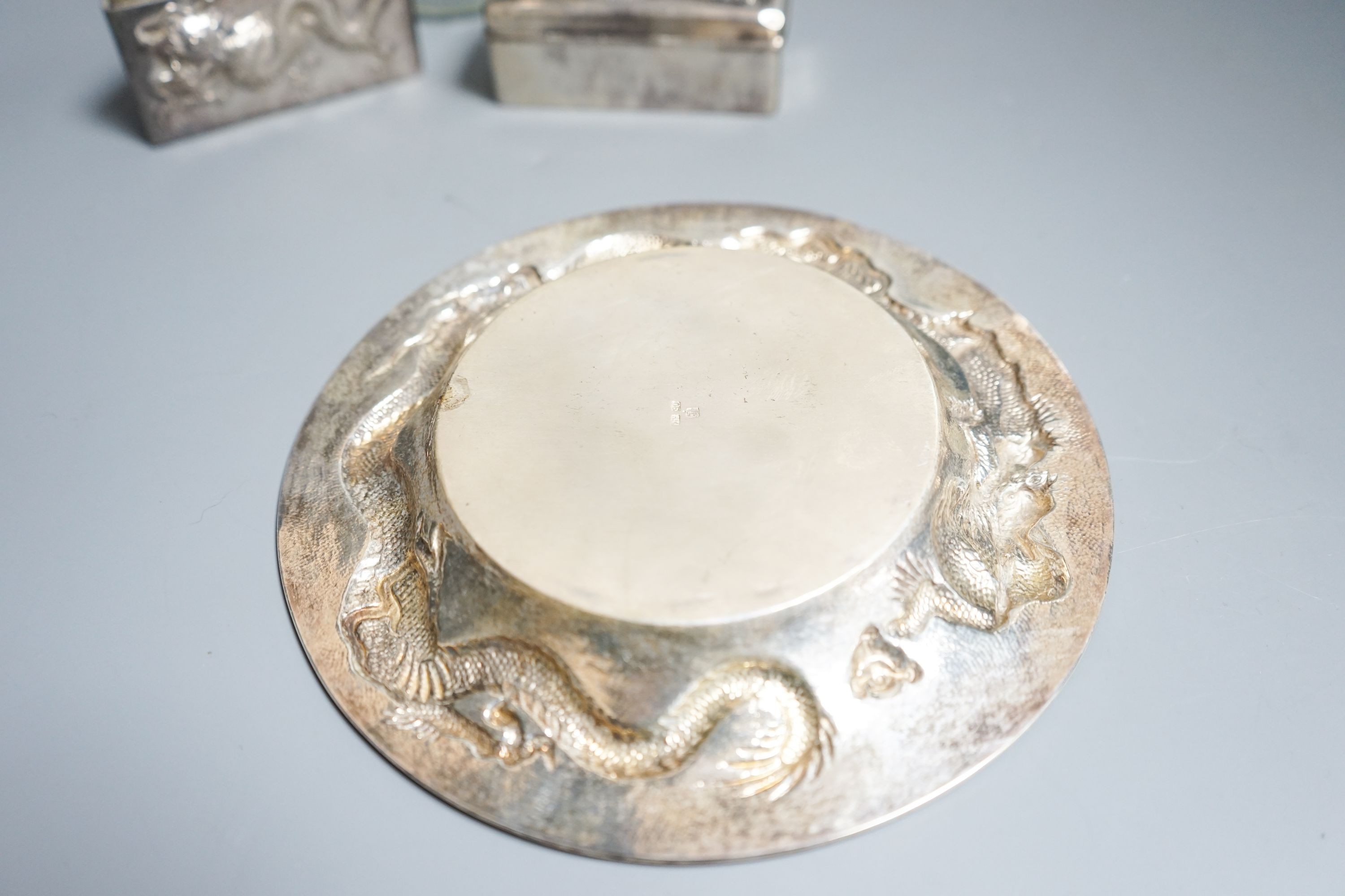 A Chinese white metal dish by Wang Hing, 18.4cm and a similar rectangular box, a white metal mounted jar by Tack Hing and an unmarked blotter.